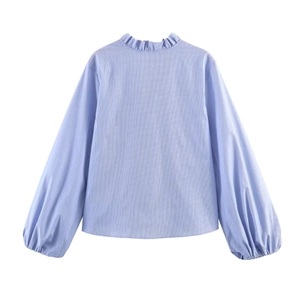 Detail of light blue striped poplin shirt featuring ruffle collar and lantern sleeves