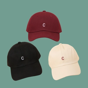 Three embroidered letter C cotton baseball caps in burgundy, black, and beige colors