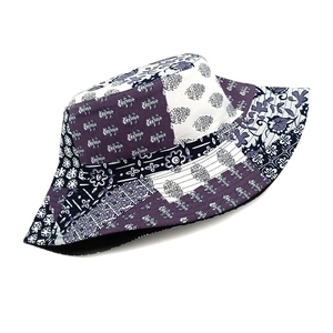 Detailed close-up of paisley pattern and stitching on a reversible cotton bucket hat