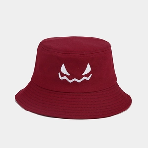 Detail of white ghost face embroidery on burgundy cotton fisherman hat for Halloween