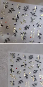 Macro detail of Chinese style nail stickers featuring 3D embossed gold bamboo and black ink motifs