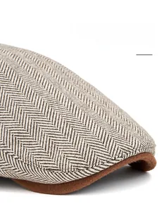 Macro detail of men's newsboy hat brim with brown herringbone tweed fabric texture