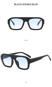 Detail view of double-bridge aviator sunglasses with black frames and gradient blue lenses
