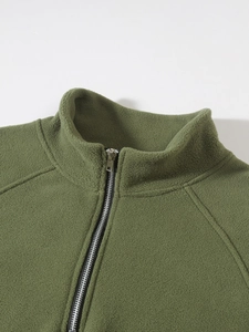 Close-up of army green coral fleece jacket detailing the stand collar and smooth zipper