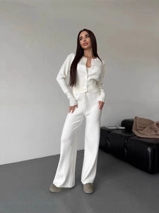 Minimalist white knit two-piece set featuring a buttoned cardigan and wide-leg trousers