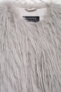 Close-up of lapel and texture on light gray faux fur coat with brand label detail