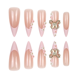 French press-on nails with 3D floral accents and gold butterfly charms on stiletto shape