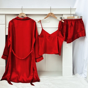 Red three-piece satin pajama set with long robe, camisole, and ruffled shorts