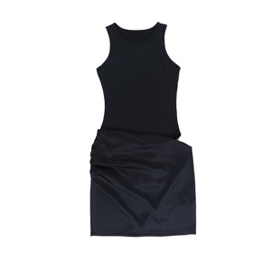 Detail of black sleeveless mini dress featuring ribbed bodice and draped satin skirt