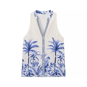 Women's white sleeveless V-neck top with blue tropical parrot print and button closure