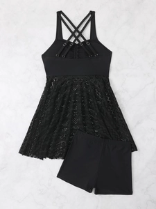 Close-up of black two-piece swimsuit featuring lace hem and crisscross back straps detail