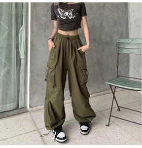 Detail view of military green cargo pants with high waist and adjustable drawstring cuffs