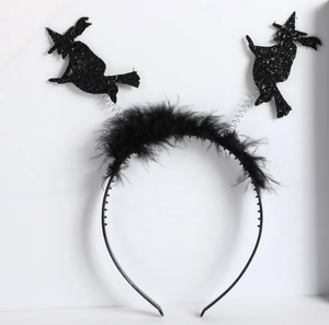 Detailed view of Halloween witch headband with black feathers and sparkling glitter finish