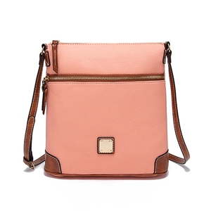 Close-up of pink litchi grain texture and brown leather stitching on crossbody bag