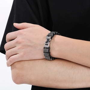 Detail of men's punk leather braid bracelet with stainless steel dragon bead and lock