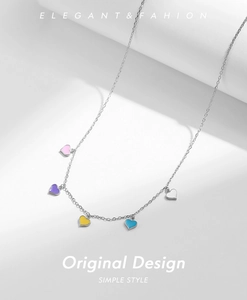 Close-up of five colorful enamel heart charms on a sleek silver chain necklace