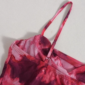 Close-up of adjustable spaghetti straps and metal buckles on mesh bodysuit
