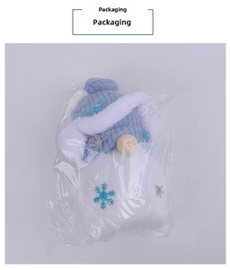 Christmas gnome plush toy with blue snowflake knitted hat in clear plastic packaging