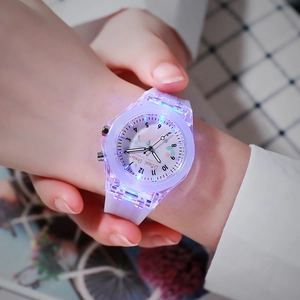Close-up of LED glowing children's watch with purple silicone strap and luminous display