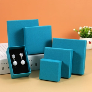 Detailed view of stackable light blue jewelry gift boxes for rings and necklaces