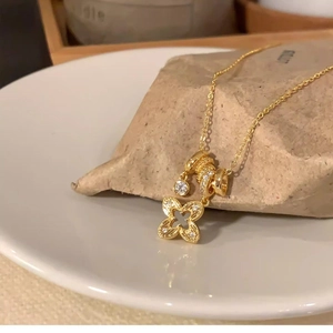 Elegant gold flower pendant necklace with zircon crystals and multi-layered charms