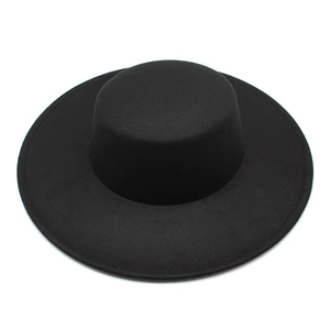 Top view of a wide-brimmed black wool felt boater hat with a flat crown design
