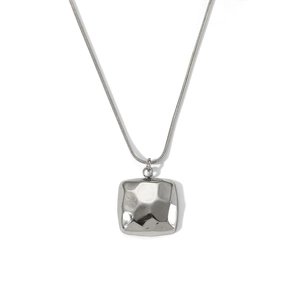 Detailed close-up of a silver square hammered texture pendant on a delicate snake chain