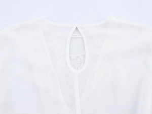 Detail of white chiffon blouse back with lace拼接 and teardrop cutout button closure