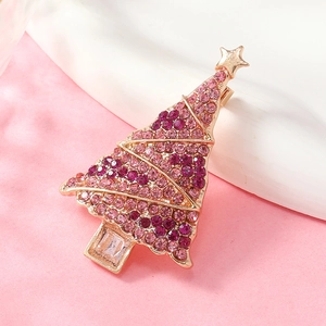 Macro detail of Christmas tree brooch with pink crystals and rose gold plating