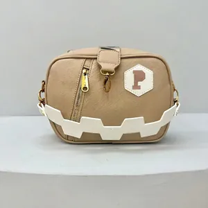 Macro view of khaki crossbody bag with textured leather, golden zipper and P logo