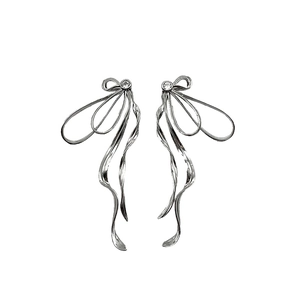 Elegant silver bow earrings with sparkling cubic zirconia and flowing metal tassels