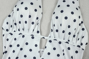 Close-up of ruched halter neckline and polka dot pattern on women bikini swimwear