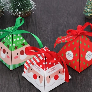 Pyramid Christmas gift boxes in red and green with festive ribbons and merry christmas print