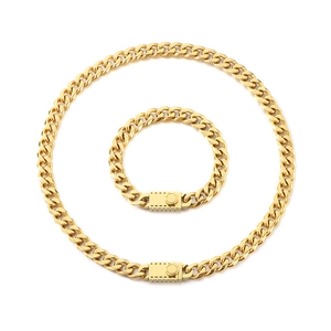 Golden Cuban link necklace and bracelet set with polished square clasps on white background