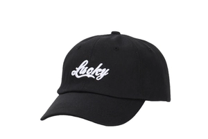 Detail of white Lucky embroidery on the front of a black cotton baseball cap