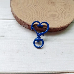 Macro detail of heart-shaped dark blue metal swivel clasp for DIY keychains