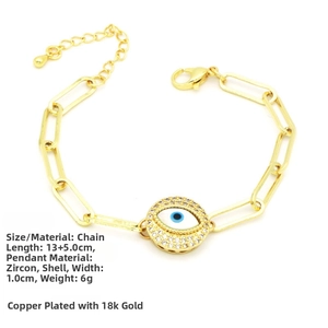 Detail of 18k gold plated paperclip bracelet with zircon evil eye and shell pendant