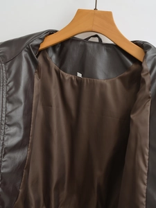Detail of chocolate brown faux leather jacket collar and smooth satin lining on a hanger