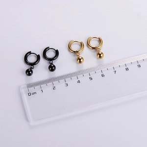 Polished stainless steel hoop earrings with bead pendants in gold and black finish