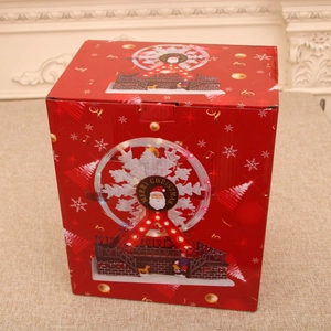 Detailed view of the red festive Christmas music box packaging with merry christmas text