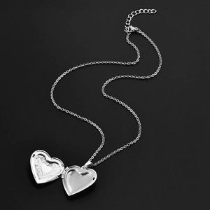 Silver heart locket necklace with floral engraving and space for a photo inside