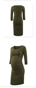 Detail view of olive green maternity dress showing ruching and high elasticity fabric