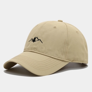 Close-up of khaki baseball cap featuring detailed mountain embroidery and durable stitching