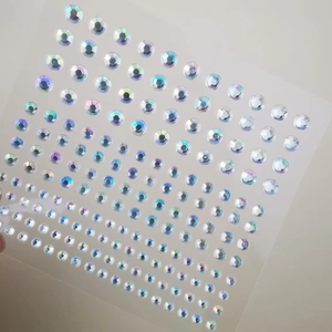 Detailed view of iridescent butterfly facial crystals and mixed size adhesive makeup gems