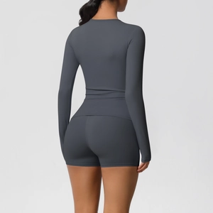 Close-up of charcoal grey yoga set featuring high-waist shorts and form-fitting long sleeve top