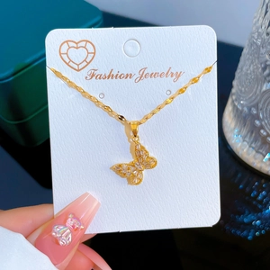 Gold butterfly necklace with sparkling zircon wings on a delicate twisted water wave chain