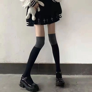 Detailed view of gray and black color-block over-the-knee socks with knit texture