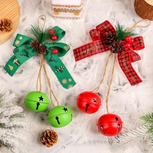 Christmas iron bells with plaid bows, pine cones and berries on a snowy background