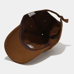 Brown cotton baseball cap with frog mushroom embroidery showing interior lining and cotton tag