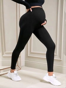 High waist seamless maternity leggings in black ribbed knit fabric with belly support